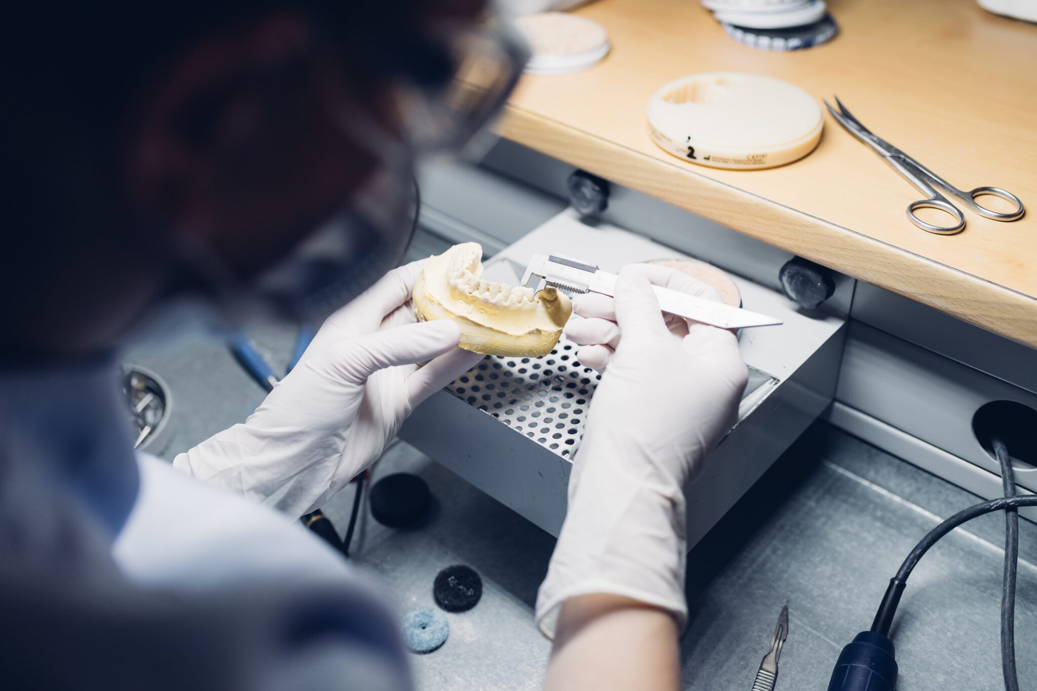 Dentist making denture in laboratory